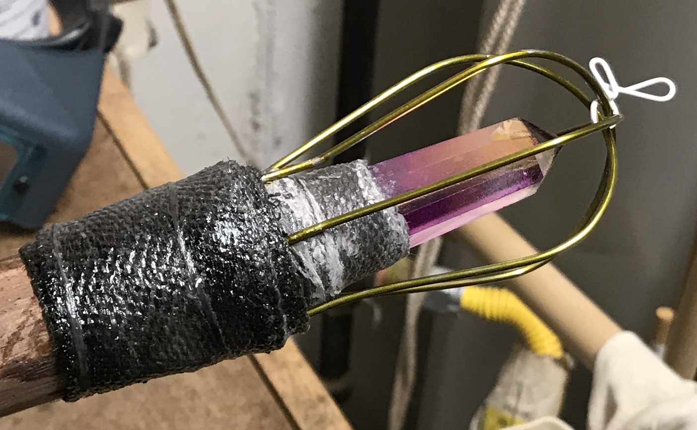 A wrapped wired cage around the crystal